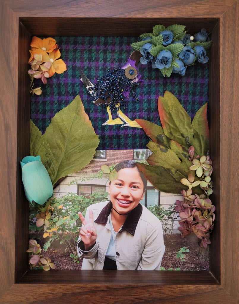 Fake flowers surrounding photograph of Lindsay Pineda.