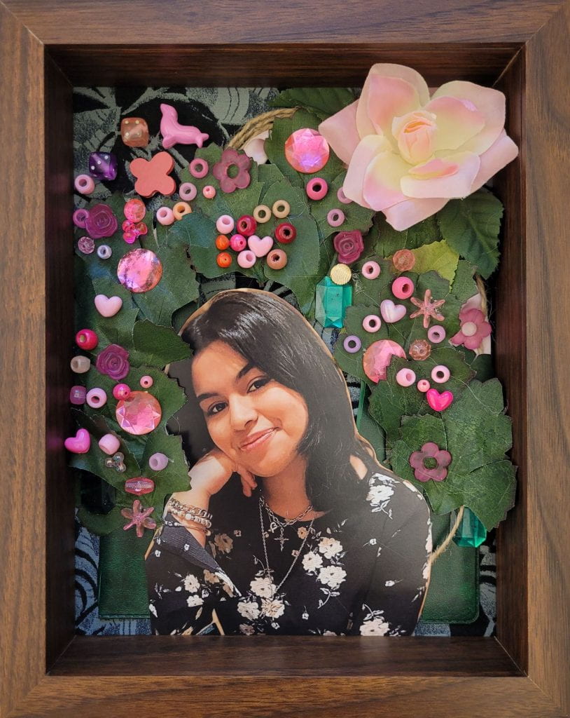 Flower and beads spread around surrounding a photograph of Lia Hernandez.