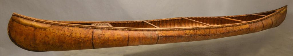 A brown canoe made of birchbark.