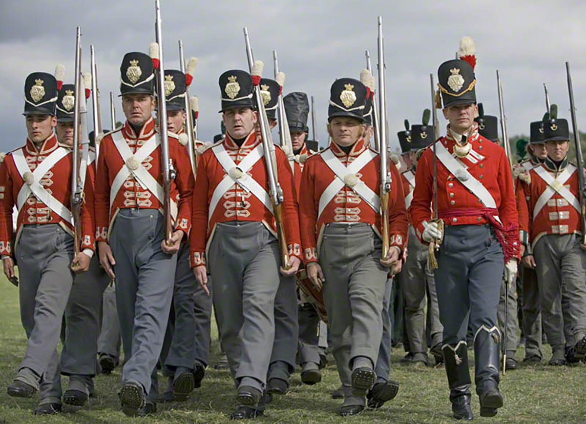 A military group known as the 33rd Regiment of Foot Wellingtons Redcoat marching in formation.